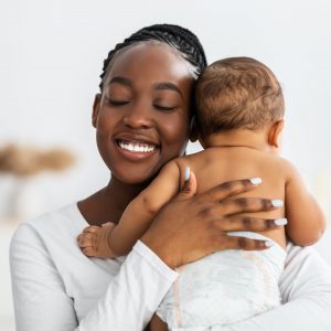 African American mom hugging her cute infant